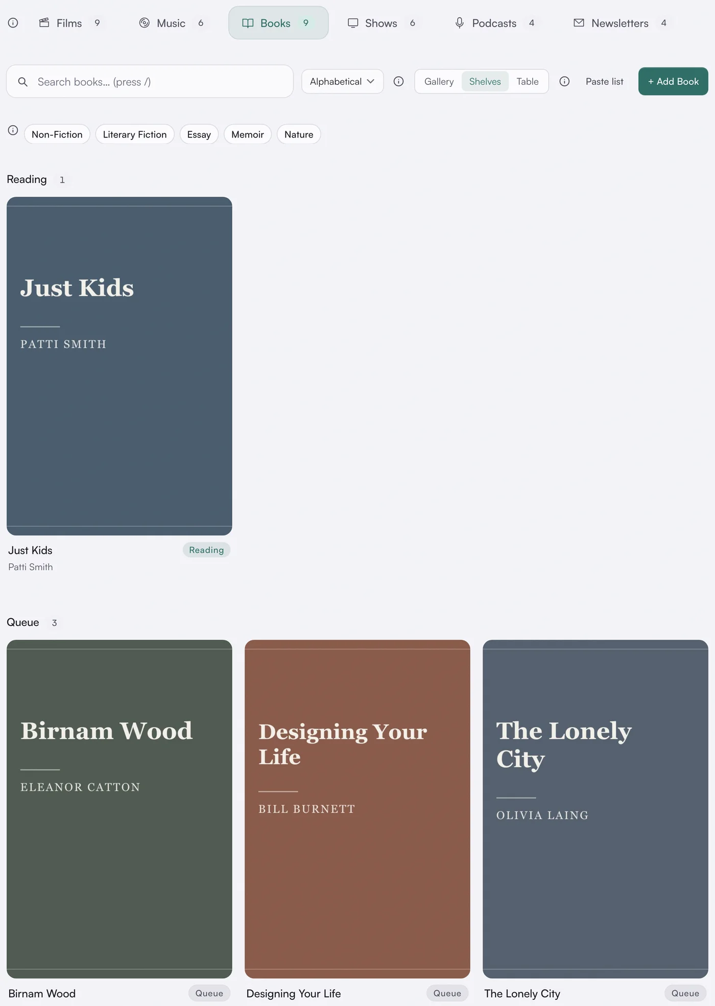 asambl's media library on the Books tab in shelves view: a Reading shelf holding Just Kids by Patti Smith, and a Queue shelf holding Birnam Wood, Designing Your Life and The Lonely City, each shown as a plain typographic cover.